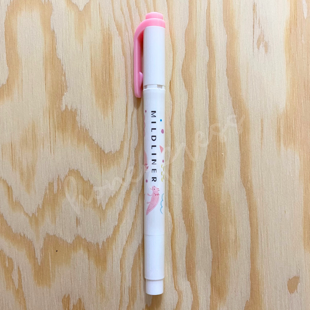 An upright highlighter with a pink colored cap, white body, and a pink axolotl image.