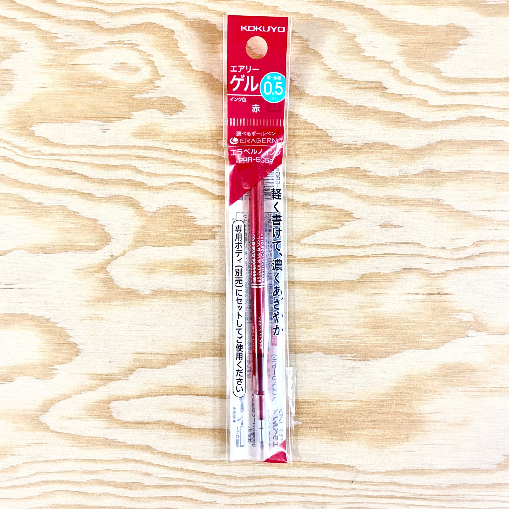 A refill cartridge with red ink in its original packaging.