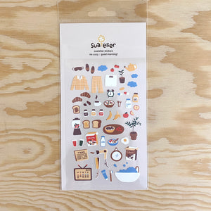 A sticker sheet with things related to the morning, such as pajamas, breakfast foods, newspapers, alarm clock, brushing your teeth and hair.
