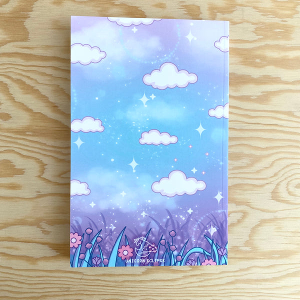 The back of the journal that has the same blue and purple cosmic background with grass and flowers on the bottom and white clouds.