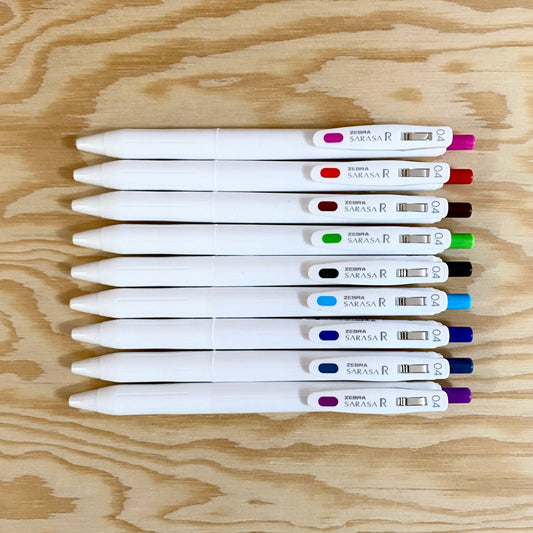 picture of white barreled click pens that have sarasa r writting on the clip. Colors include magenta, red, dark red, lime green, dark green, light blue, blue, blue black, and purple